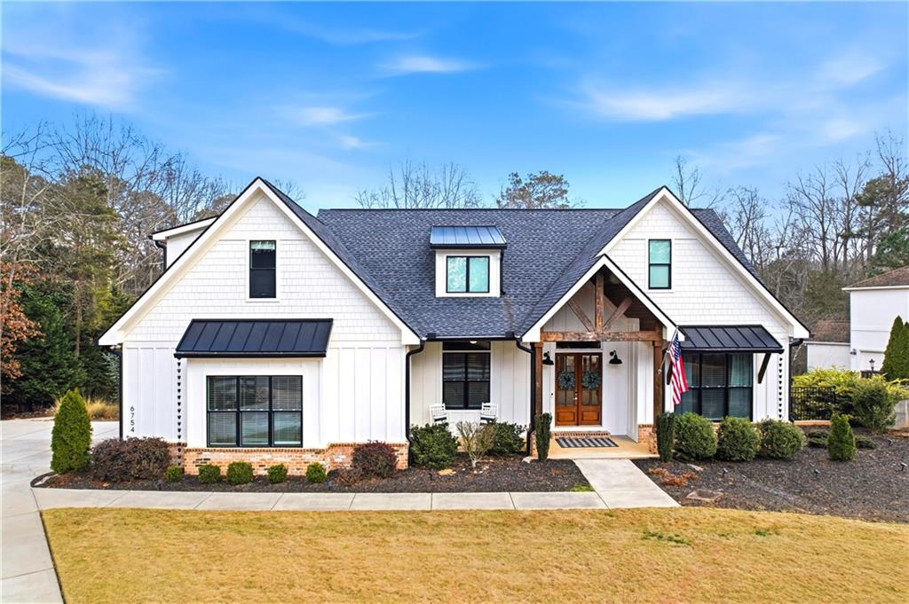 6754 Gaines Ferry Road Flowery Branch, GA 30542 - Photo 75 of 85 a front view of a house with a yard