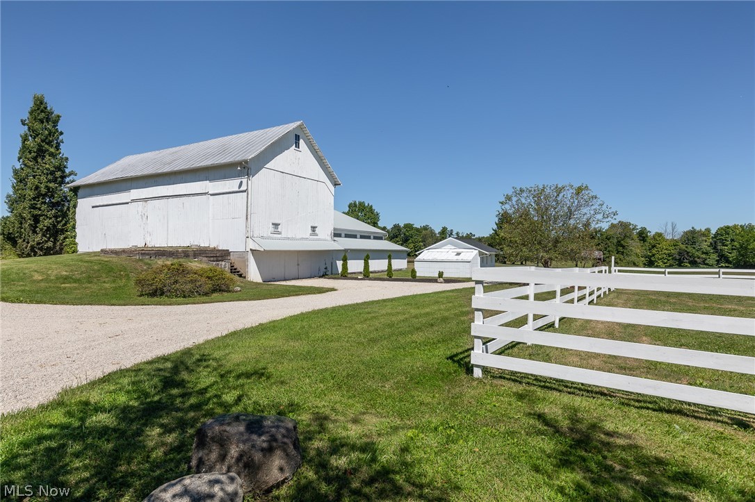 7585 Branch Road Medina, OH 44256 - Photo 8 of 35 Here's a view of the 5-10 stall barn and indoor arena with new sawdust in 2019, the garden shed, and one of the paddocks