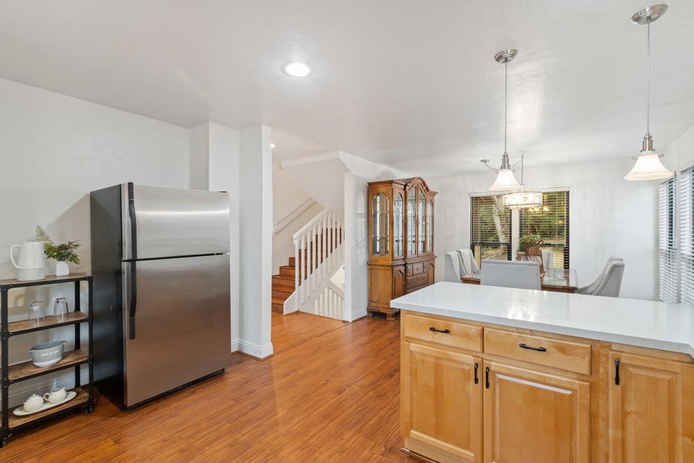 22101 Miller Ridge Road Los Gatos, CA 95033 - Photo 16 of 76 a kitchen with stainless steel appliances a sink and a refrigerator