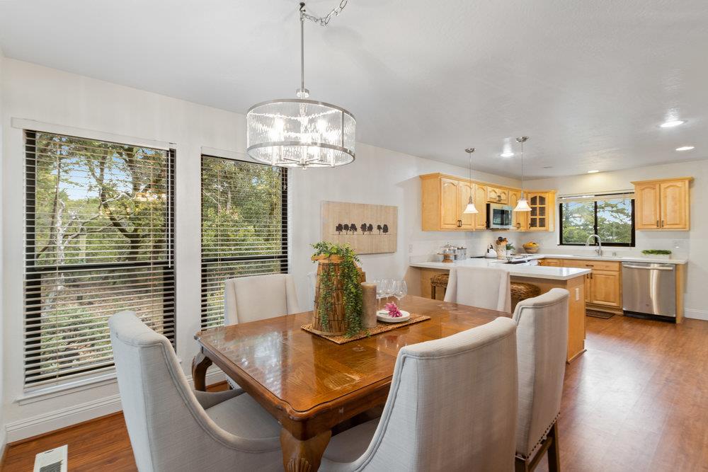 22101 Miller Ridge Road Los Gatos, CA 95033 - Photo 18 of 76 a view of a dining room and livingroom with furniture wooden floor a chandelier