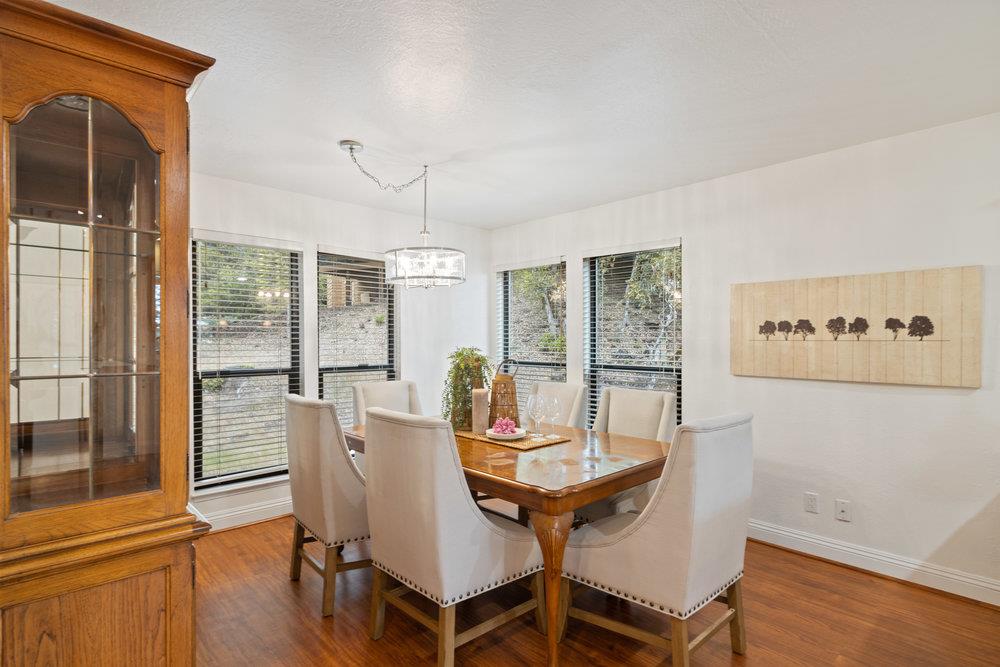 22101 Miller Ridge Road Los Gatos, CA 95033 - Photo 19 of 76 a view of a dining room with furniture window and wooden floor