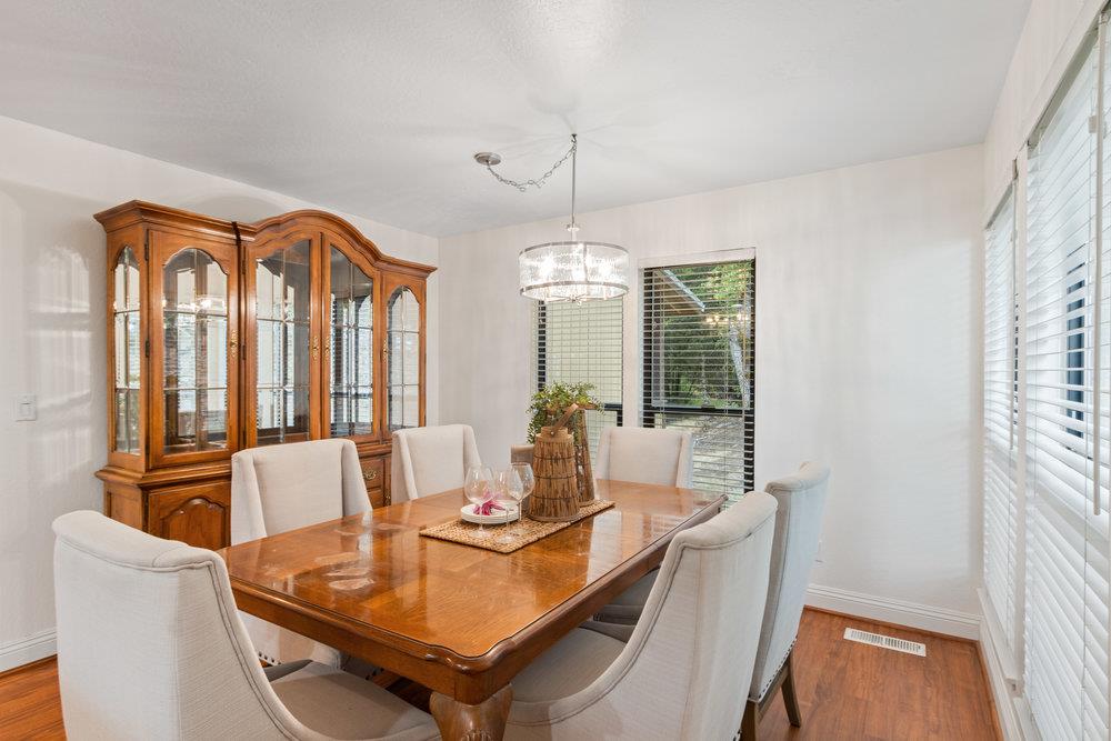 22101 Miller Ridge Road Los Gatos, CA 95033 - Photo 21 of 76 a dining room with furniture a chandelier and wooden floor