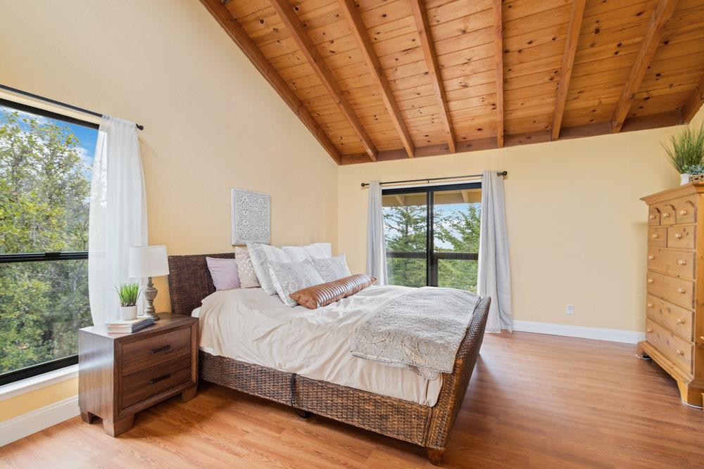 22101 Miller Ridge Road Los Gatos, CA 95033 - Photo 27 of 76 a large bedroom with a bed and a window