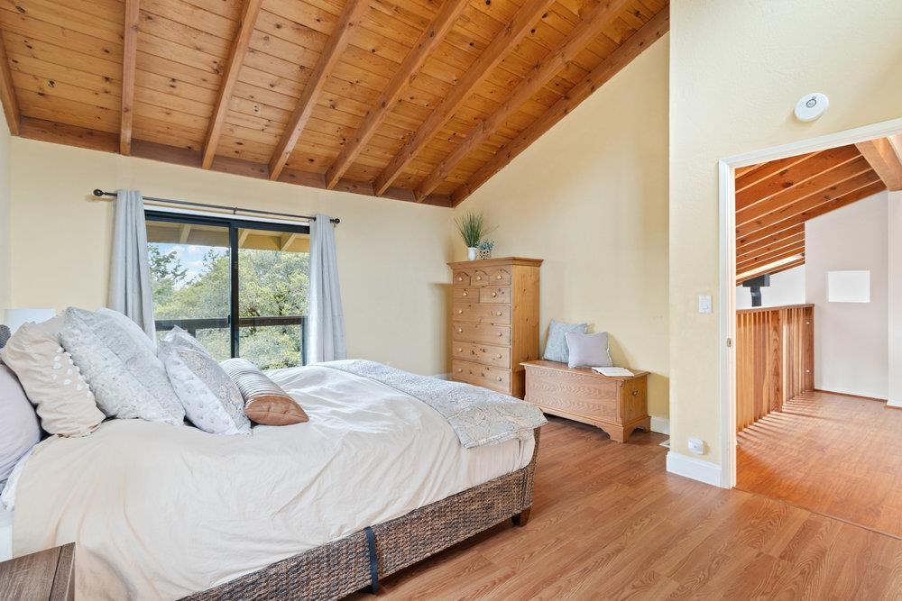 22101 Miller Ridge Road Los Gatos, CA 95033 - Photo 29 of 76 a bedroom with a bed and wooden floor