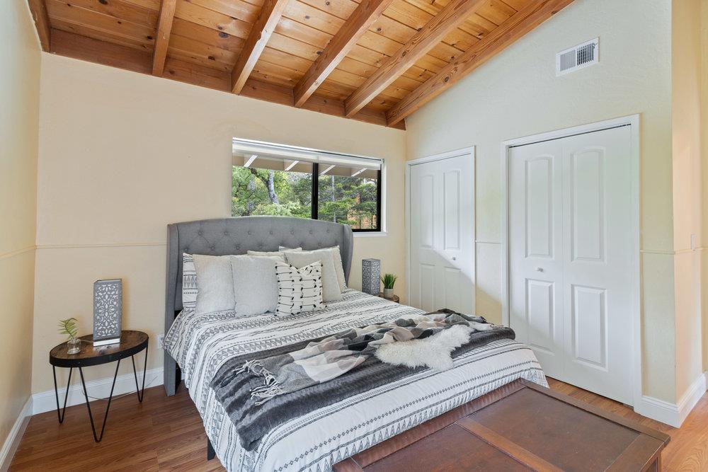 22101 Miller Ridge Road Los Gatos, CA 95033 - Photo 36 of 76 a bedroom with a bed and a chair