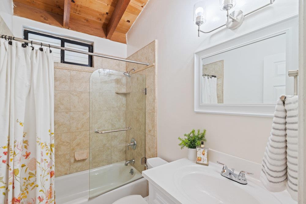 22101 Miller Ridge Road Los Gatos, CA 95033 - Photo 37 of 76 a bathroom with a sink and a mirror