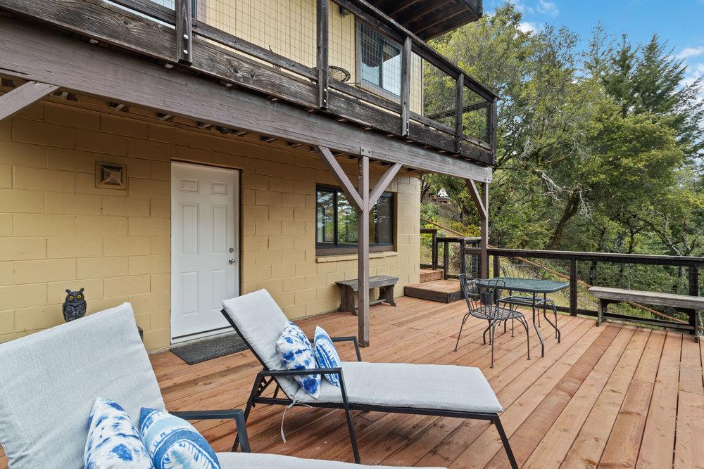 22101 Miller Ridge Road Los Gatos, CA 95033 - Photo 50 of 76 a view of a chairs and table in the balcony