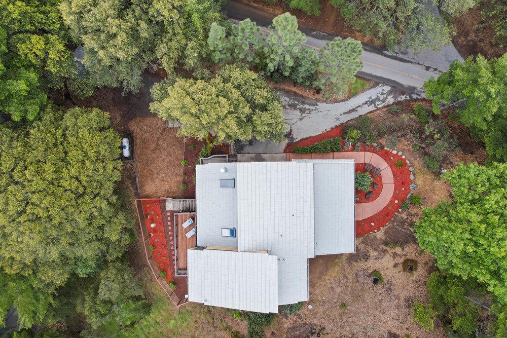 22101 Miller Ridge Road Los Gatos, CA 95033 - Photo 5 of 76 an aerial view of a house with a yard and a large tree