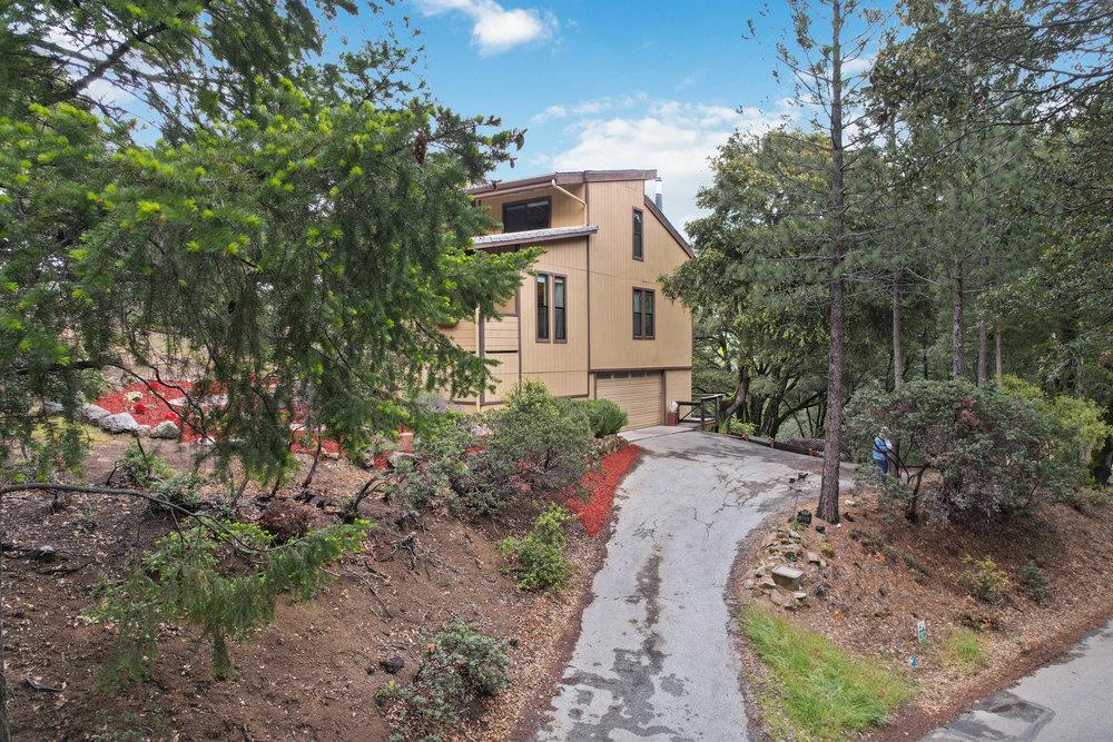 22101 Miller Ridge Road Los Gatos, CA 95033 - Photo 70 of 76 a view of a house with a small yard and a tree