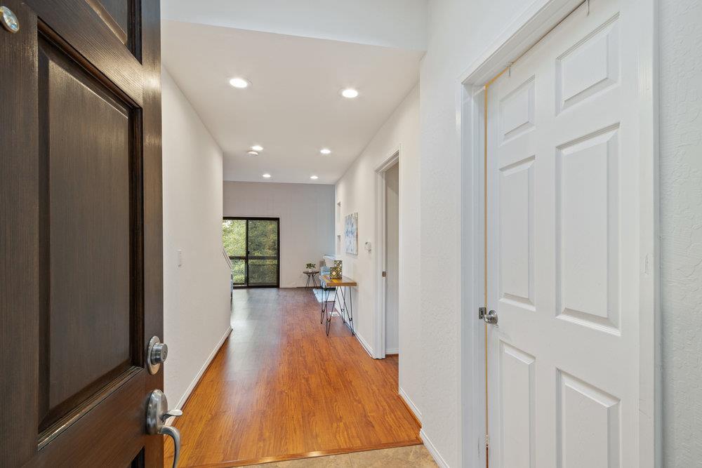 22101 Miller Ridge Road Los Gatos, CA 95033 - Photo 7 of 76 a view of a hallway with wooden floor and a bathroom