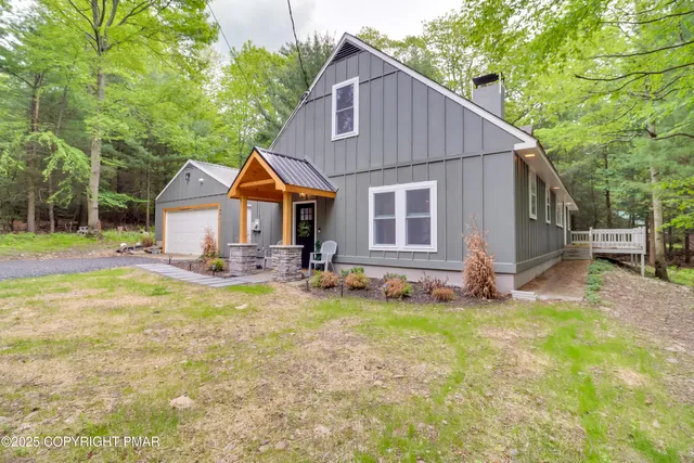 a view of a house with yard and sitting area