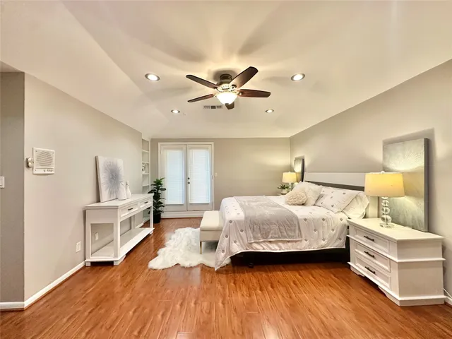 a bedroom with a bed and a ceiling fan