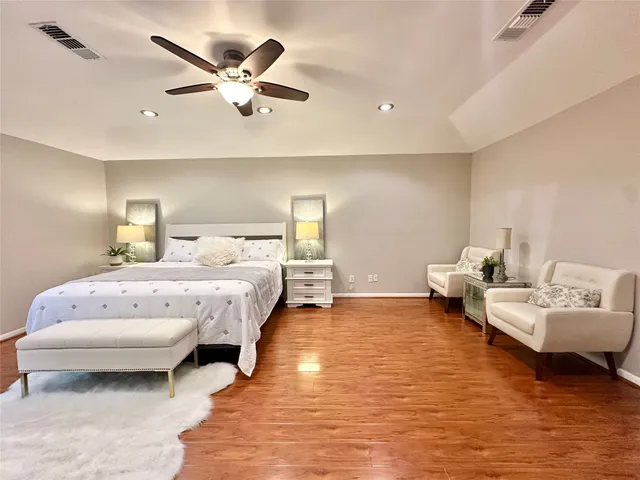 a spacious bedroom with a bed and window