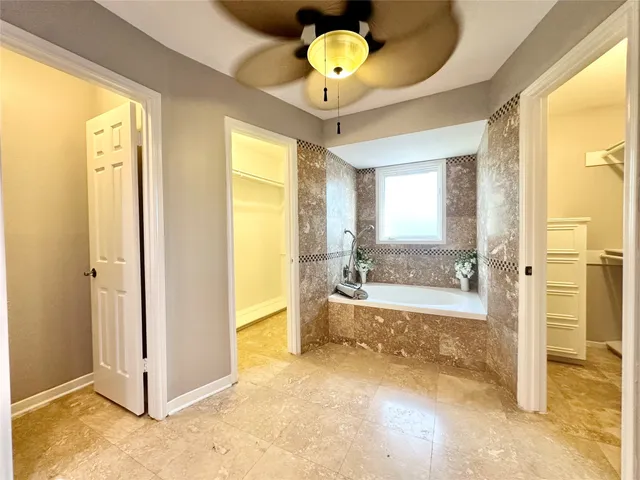 a view of a bathroom with a tub shower and a sink
