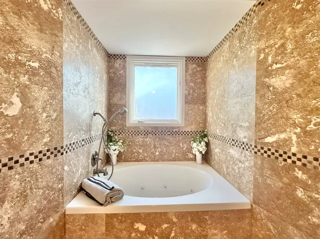 a bath tub sitting in a bathroom next to a window
