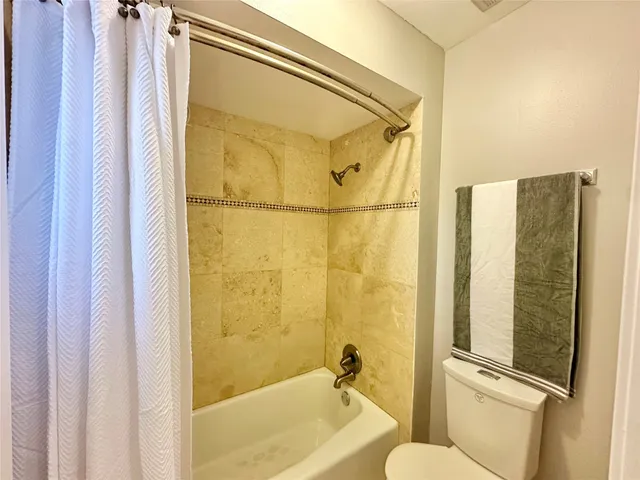 a bathroom with a shower and a toilet