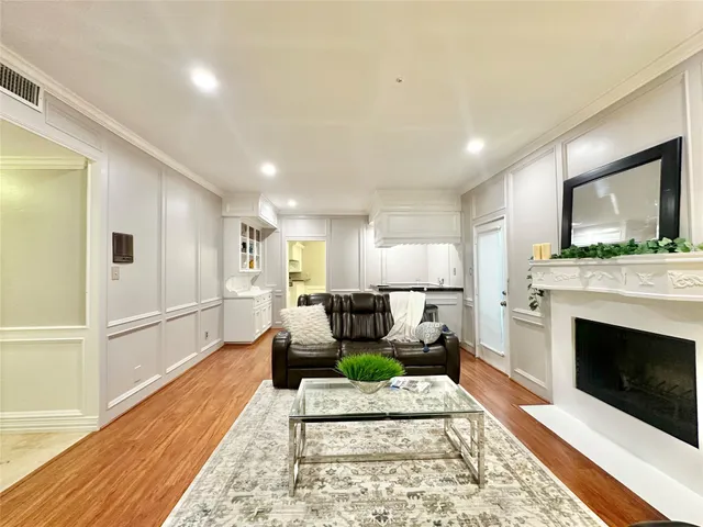 a living room with furniture a fireplace and a rug