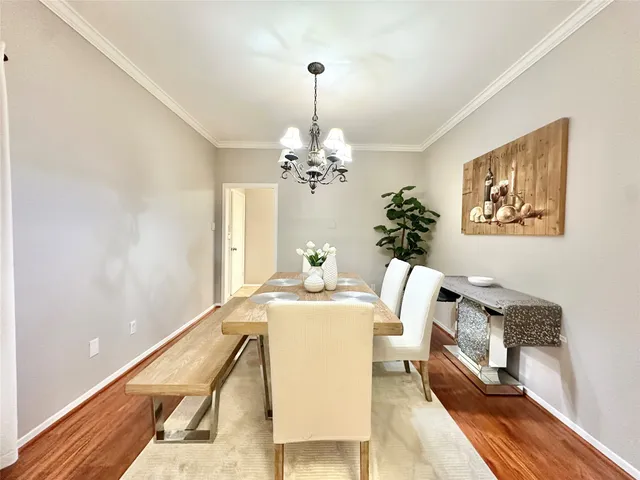 a dining room with furniture and chandelier