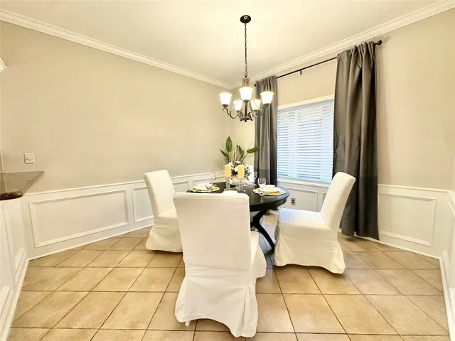 a dining room with furniture and a chandelier