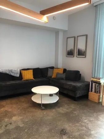 a living room with furniture and a lamp