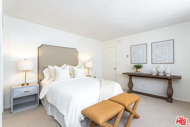 a bedroom with furniture and a lamp