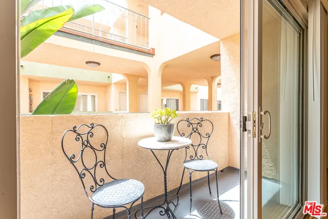 a view of a hallway with furniture and a table