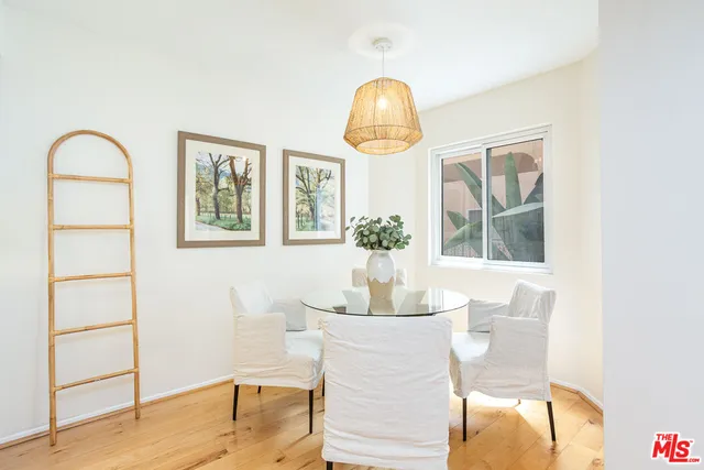 a dining room with wooden floor and breakfast area