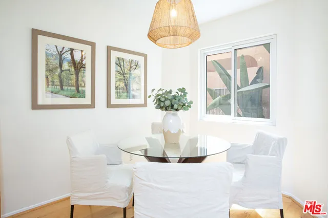 a dining room with window and chandelier
