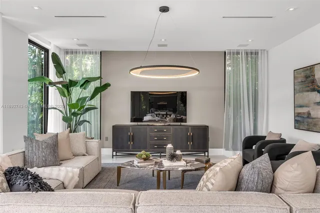 a living room with furniture or couch and a potted plant