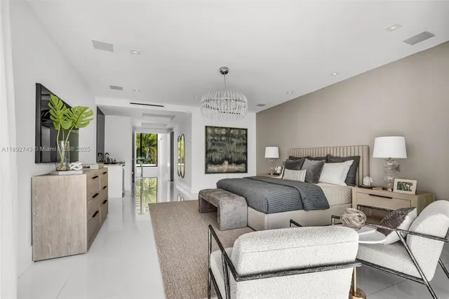 a large white bathroom with a granite countertop sink mirror and shower