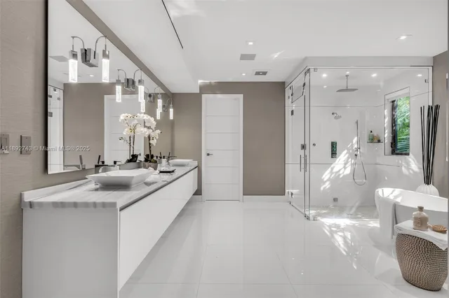 a large bathroom with a granite countertop sink mirror and a shower