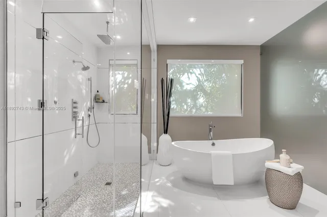 a view of a patio with table and chairs potted plants and floor to ceiling window
