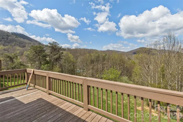 a balcony with wooden floor and fence