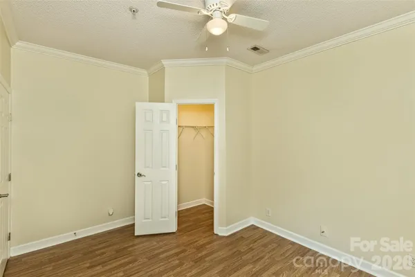 an empty room with wooden floor and white walls