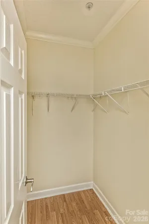 a view of walk in closet with empty racks