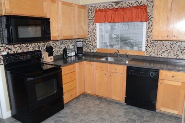 91 Jeffrey Road Springfield, MA 01119 - Photo 6 of 30 a kitchen with granite countertop a sink stove and microwave