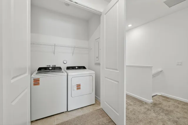 a view of storage and utility room with washer and dryer