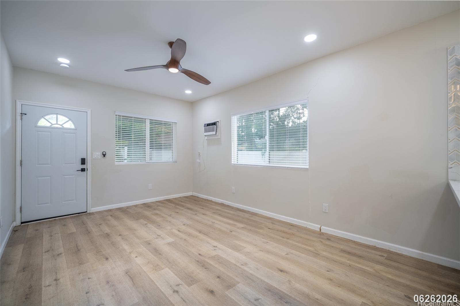 87-1409 Akowai Road Waianae, HI 96792 - Photo 12 of 25 wooden floor in an empty room with a window