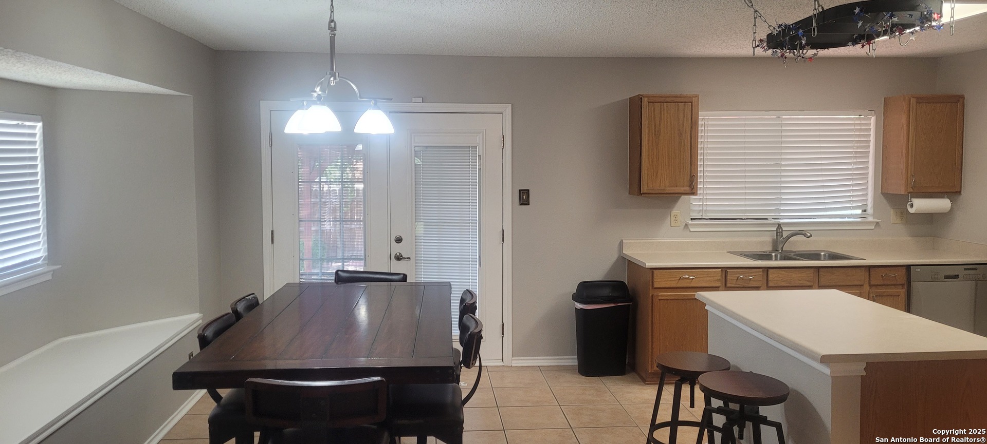7006 Raintree Place San Antonio, TX 78233 - Photo 12 of 19 a room with a chandelier furniture a sink and a window