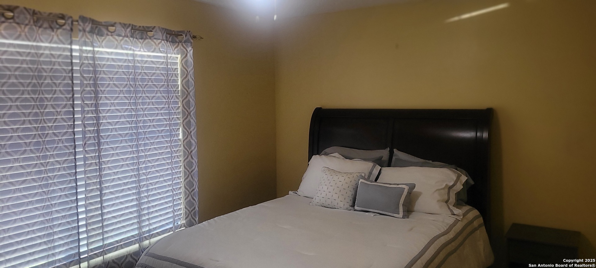 7006 Raintree Place San Antonio, TX 78233 - Photo 18 of 19 a bedroom with a bed and a night stand
