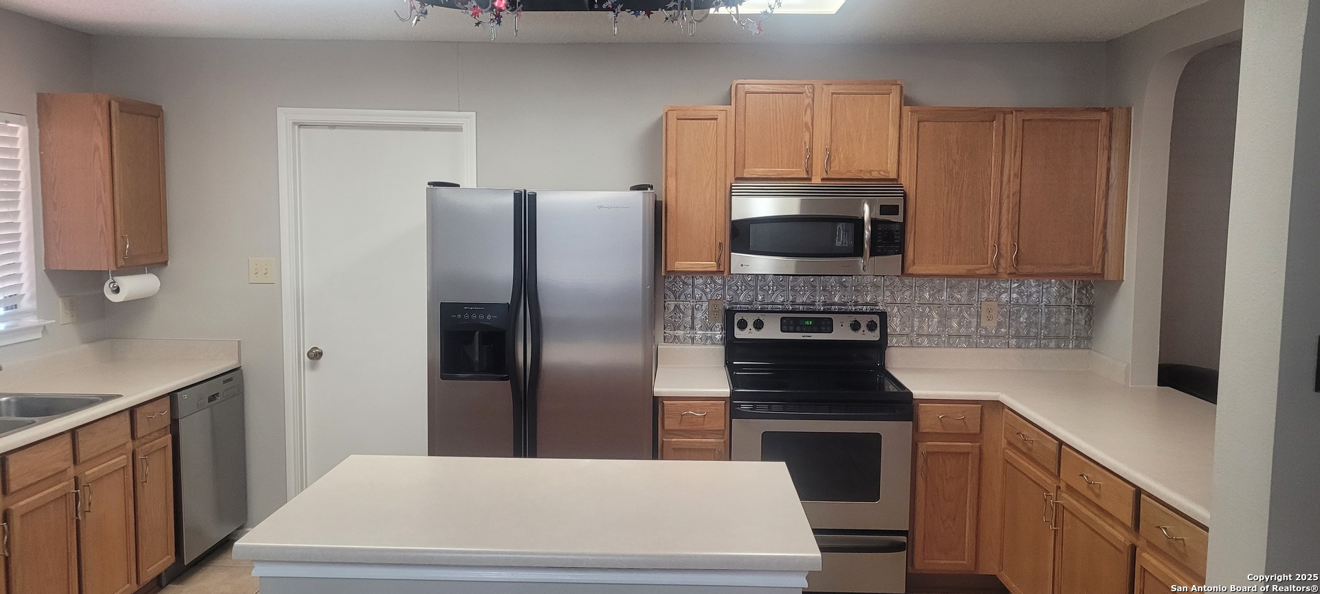 7006 Raintree Place San Antonio, TX 78233 - Photo 3 of 19 a kitchen with a refrigerator and a stove