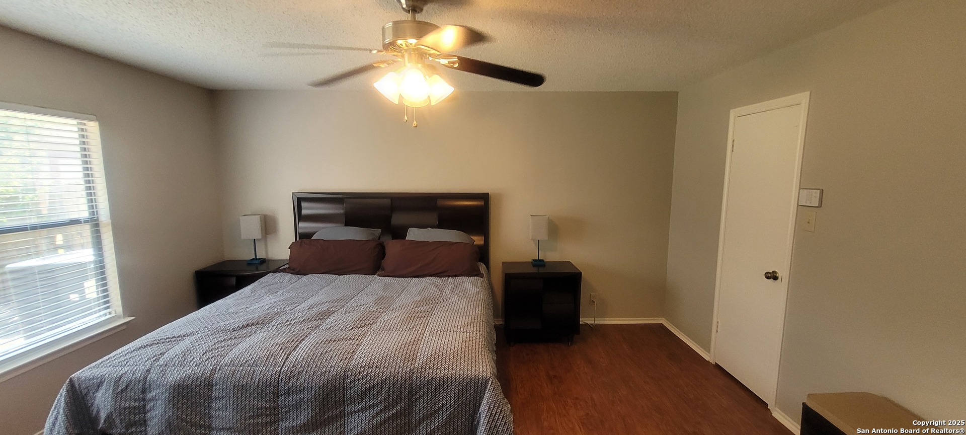 7006 Raintree Place San Antonio, TX 78233 - Photo 4 of 19 a bedroom with a bed and a chandelier