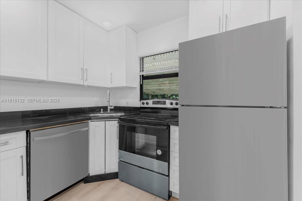 5220 Southwest 6th Street Miami, FL 33134 - Photo 12 of 56 a kitchen with cabinets appliances and a counter top