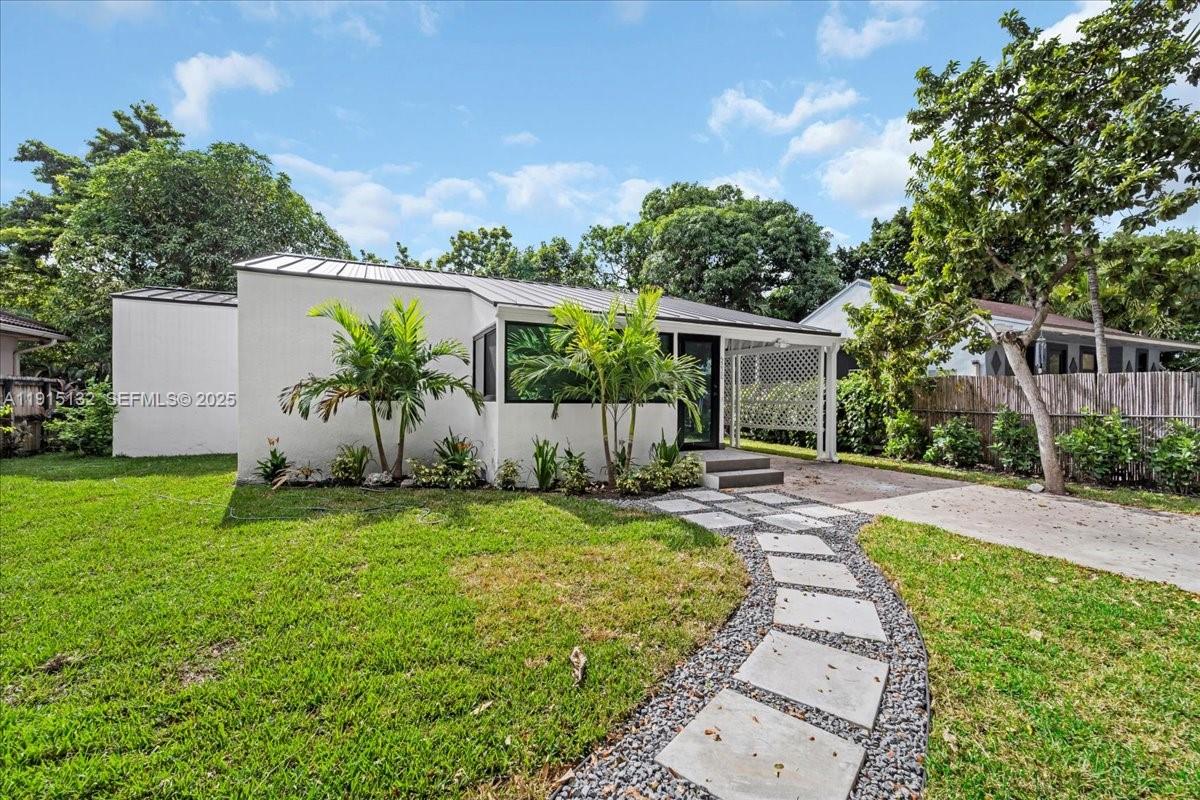 5220 Southwest 6th Street Miami, FL 33134 - Photo 15 of 56 front view of a house with a yard and potted plants