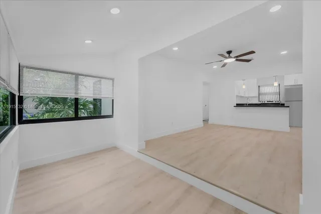 wooden floor in an empty room with a ceiling fan