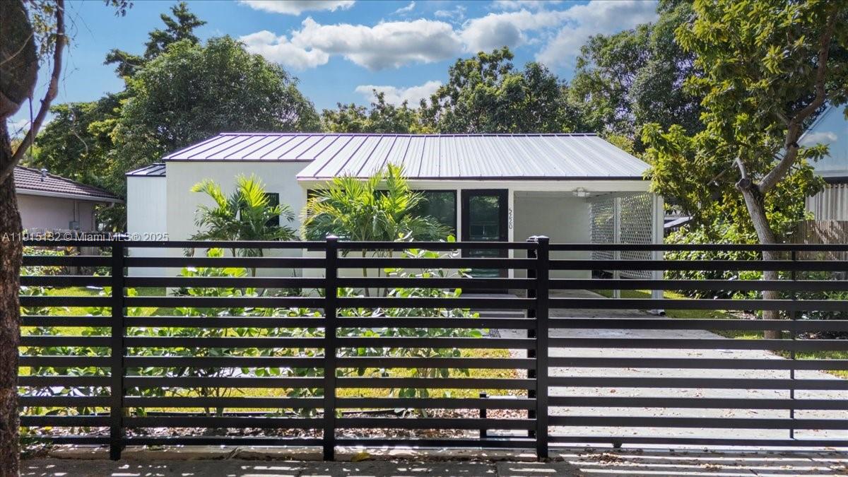 5220 Southwest 6th Street Miami, FL 33134 - Photo 2 of 56 a front view of a house with a yard