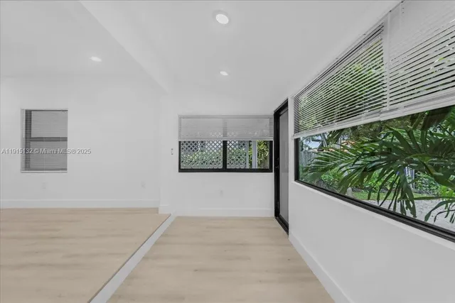 an empty room with a empty space and a ceiling fan