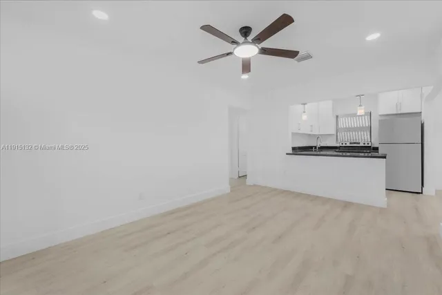 a kitchen with a refrigerator and a sink