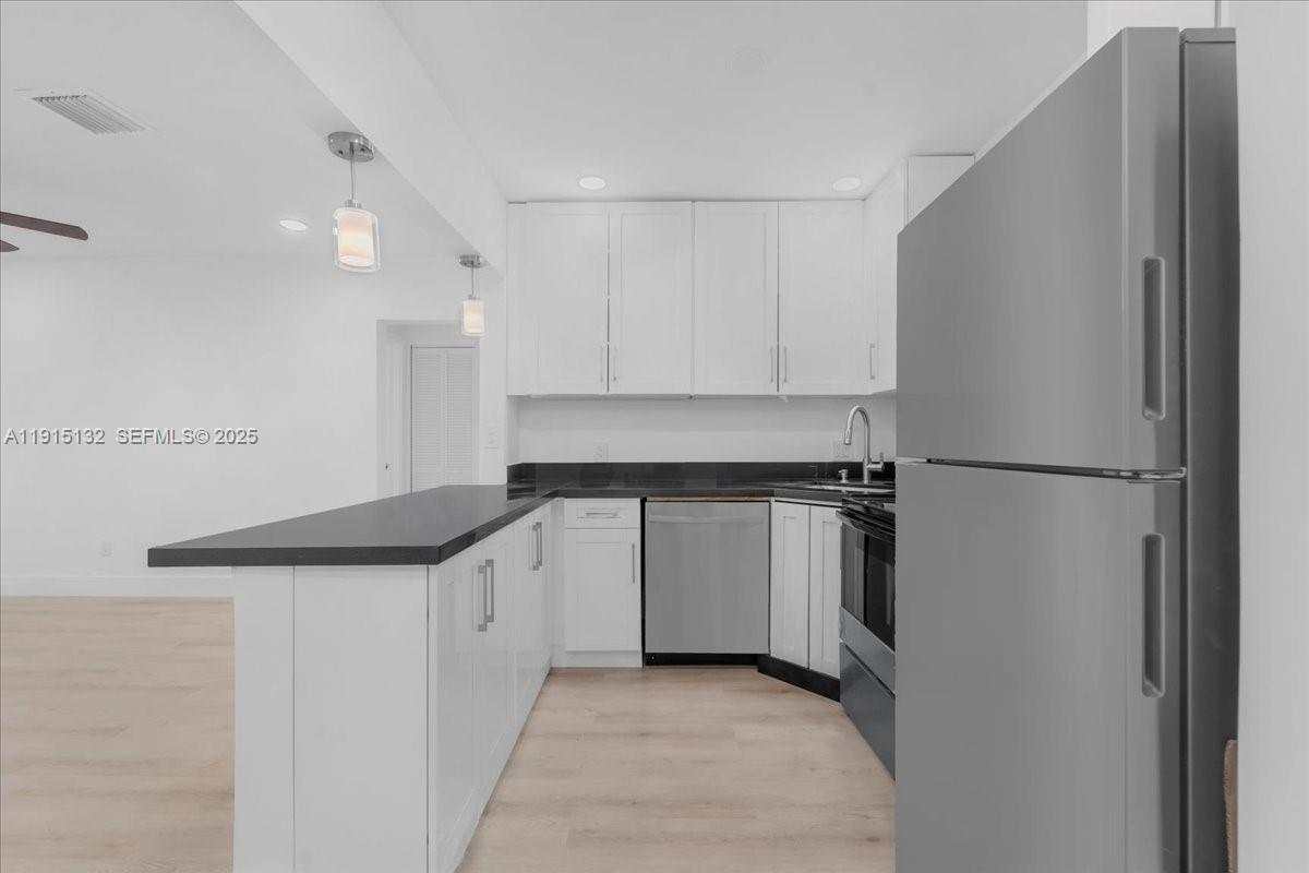 5220 Southwest 6th Street Miami, FL 33134 - Photo 25 of 56 a kitchen with a refrigerator and a sink