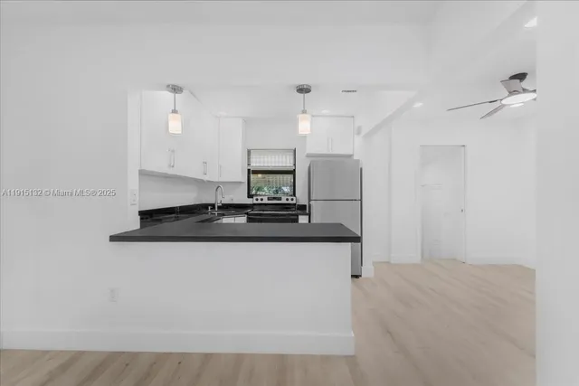 a view of room with a ceiling fan a potted plant and a ceiling fan